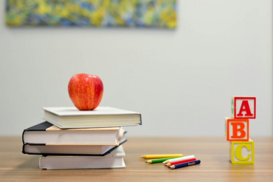 Books, pencils and an apple in a classroom